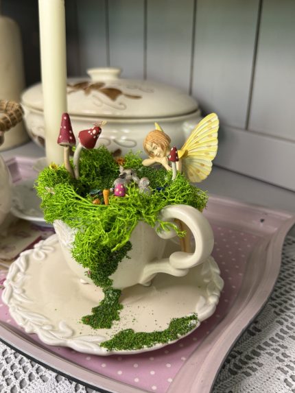 Fairy and her little bunny friends in a cup
